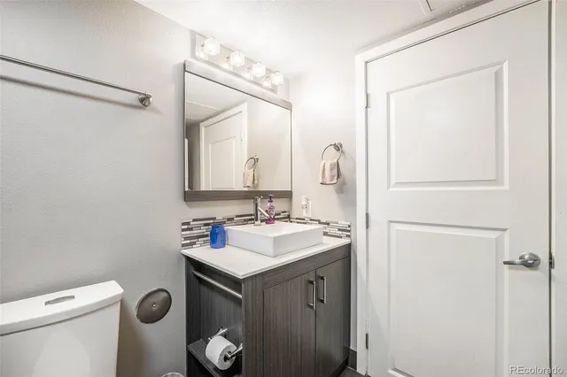 a bathroom with a sink toilet and mirror