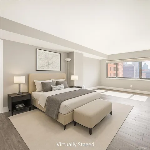 a bedroom with a large bed and a night stand