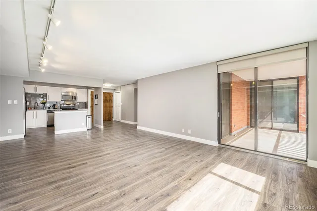 a view of empty room with wooden floor