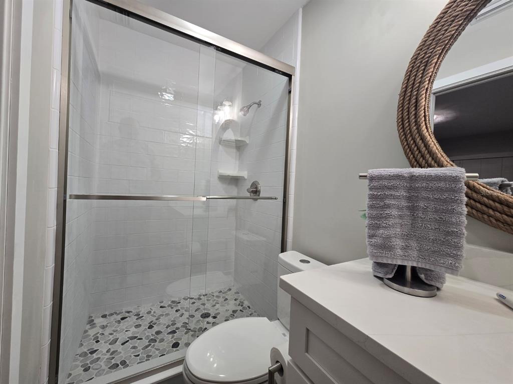 508 Shore Drive Largo, FL 33771 - Photo 16 of 31 a bathroom with a sink a toilet and shower