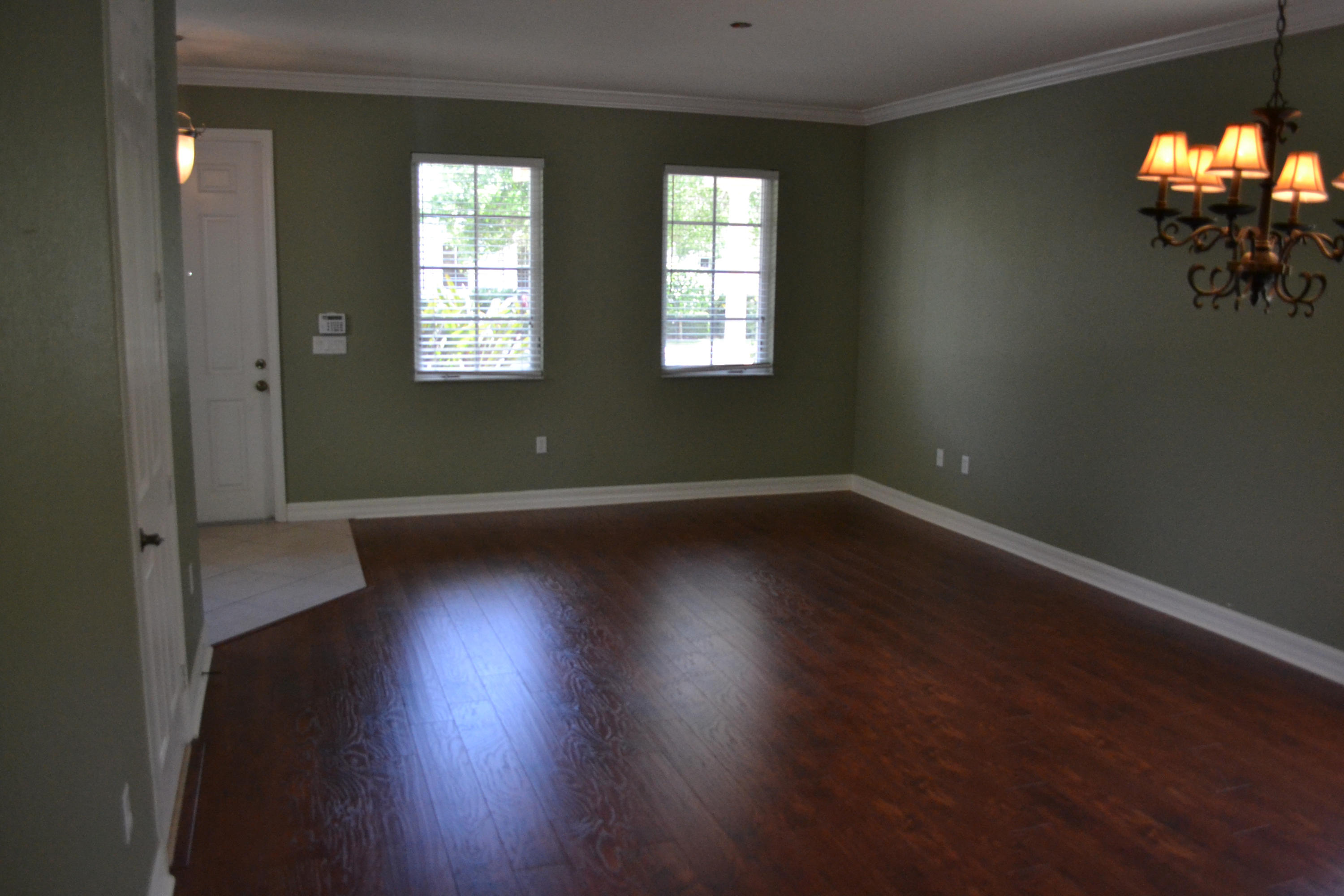 124 Dunmore Drive Jupiter, FL 33458 - Photo 2 of 10 an empty room with wooden floor and windows