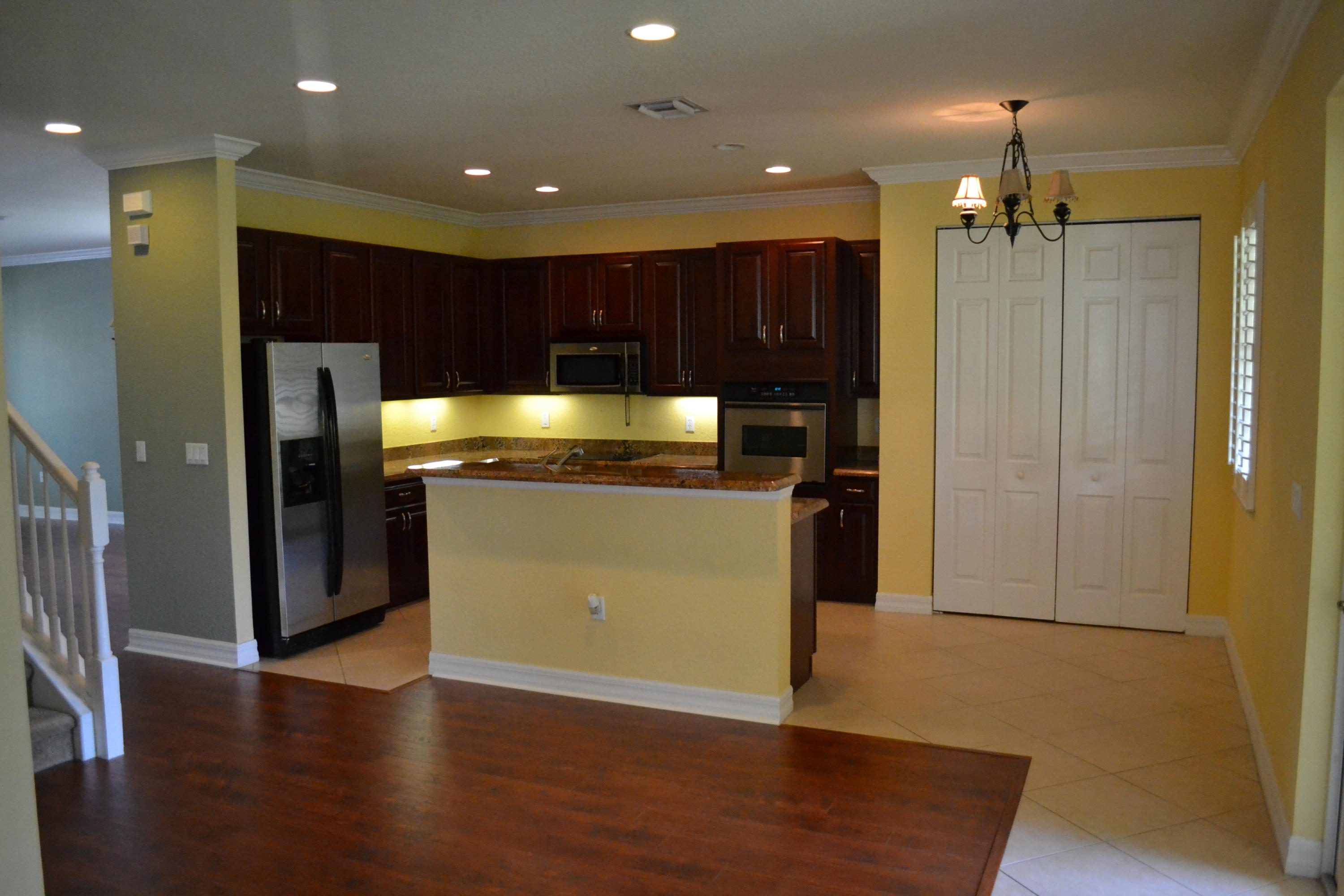 124 Dunmore Drive Jupiter, FL 33458 - Photo 4 of 10 a kitchen with kitchen island stainless steel appliances a refrigerator and a sink