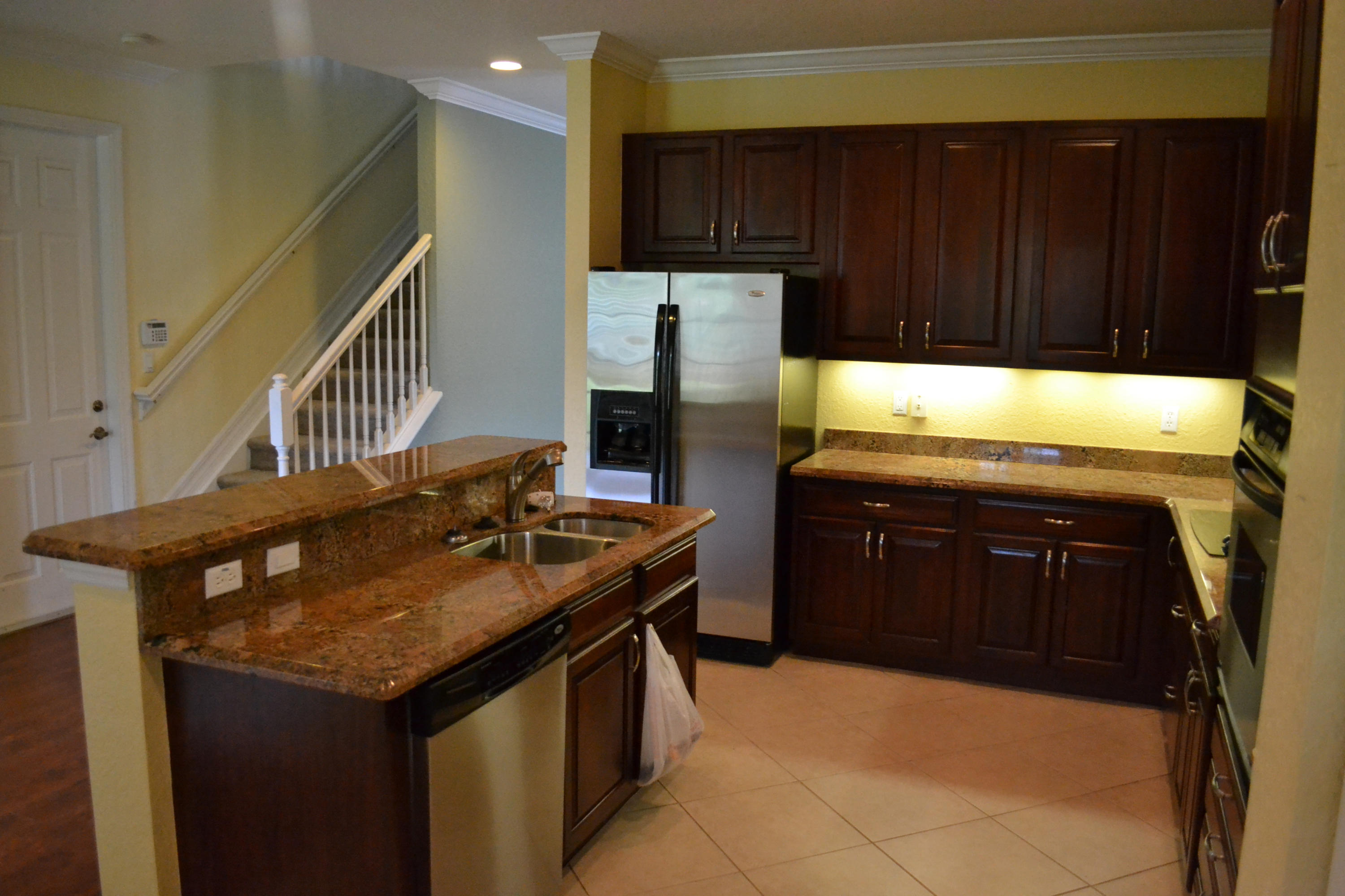 124 Dunmore Drive Jupiter, FL 33458 - Photo 5 of 10 a kitchen with granite countertop a stove a sink and a refrigerator