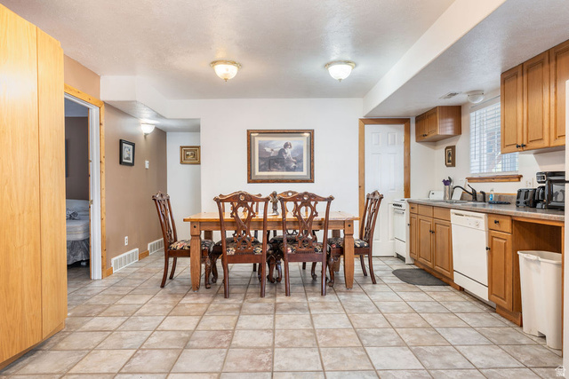 11550 Pigeon Hollow Road Spring City, UT 84662 - Photo 59 of 85 Kitchen and dining area featuring tile flooring, wooden cabinetry, and light-colored countertops