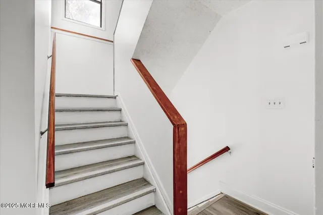 a view of hallway with wooden floor