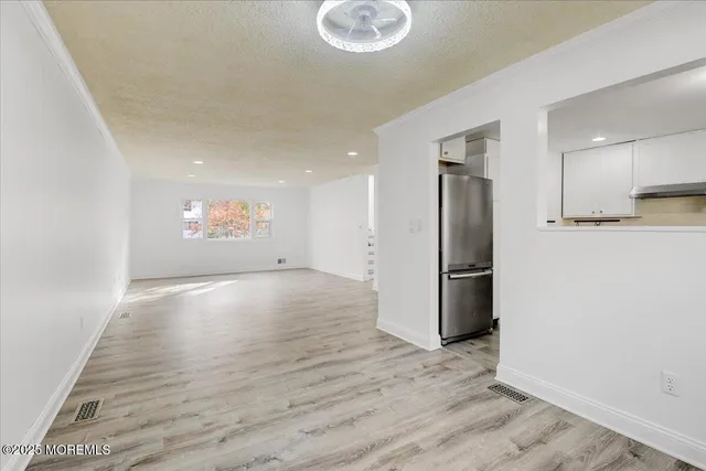 a kitchen with stainless steel appliances granite countertop a stove and white cabinets