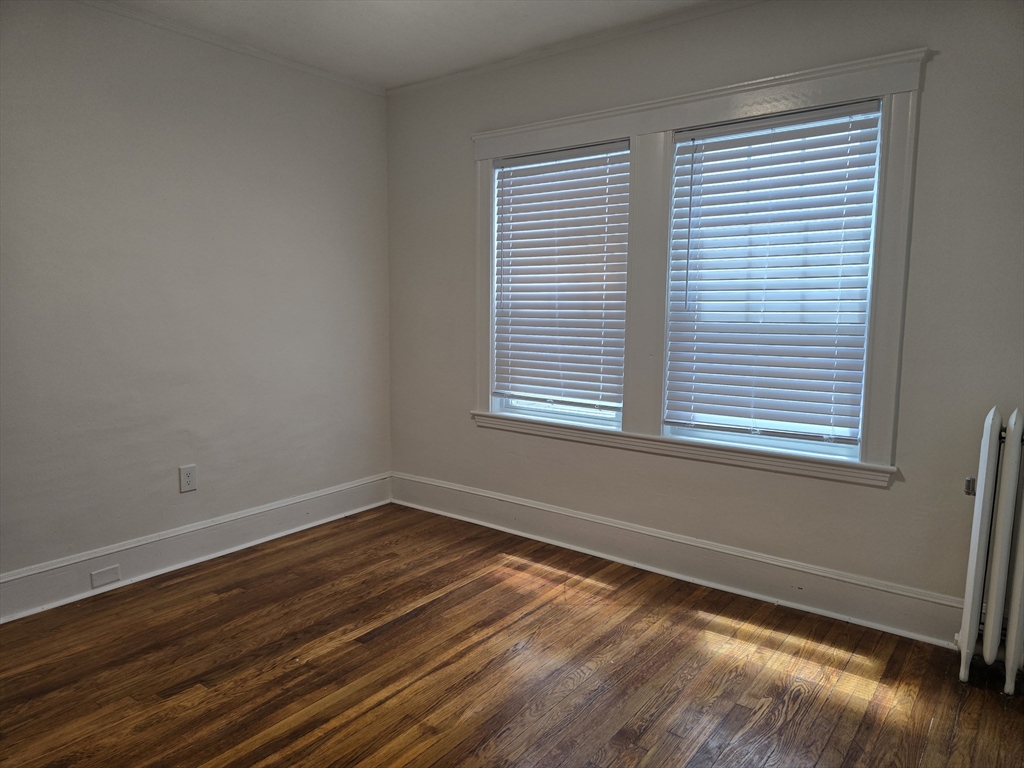 105 Fuller Street, Unit 1 Boston, MA 02124 - Photo 5 of 6 a view of a room with wooden floor and windows
