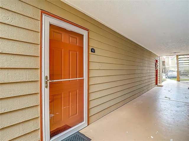 a living room with furniture wooden floor and a large window