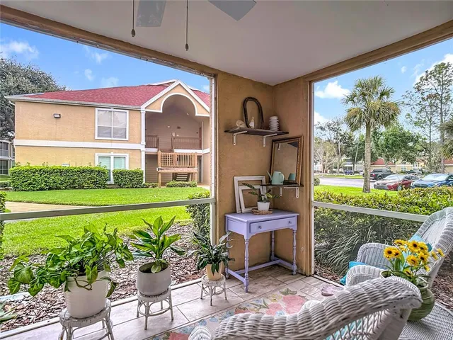 a kitchen with stainless steel appliances granite countertop a stove top oven a sink dishwasher a dining table and chairs with wooden floor