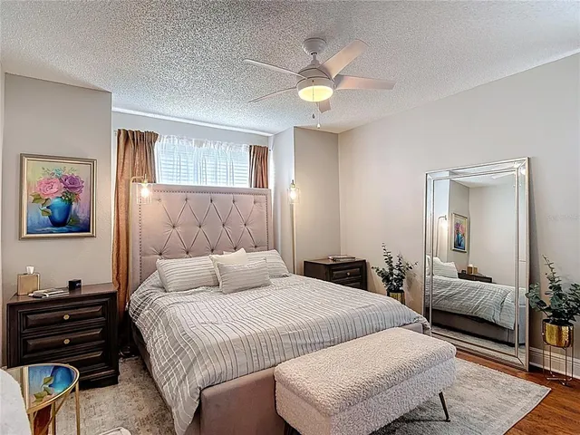 a bedroom with a bed and wooden floor