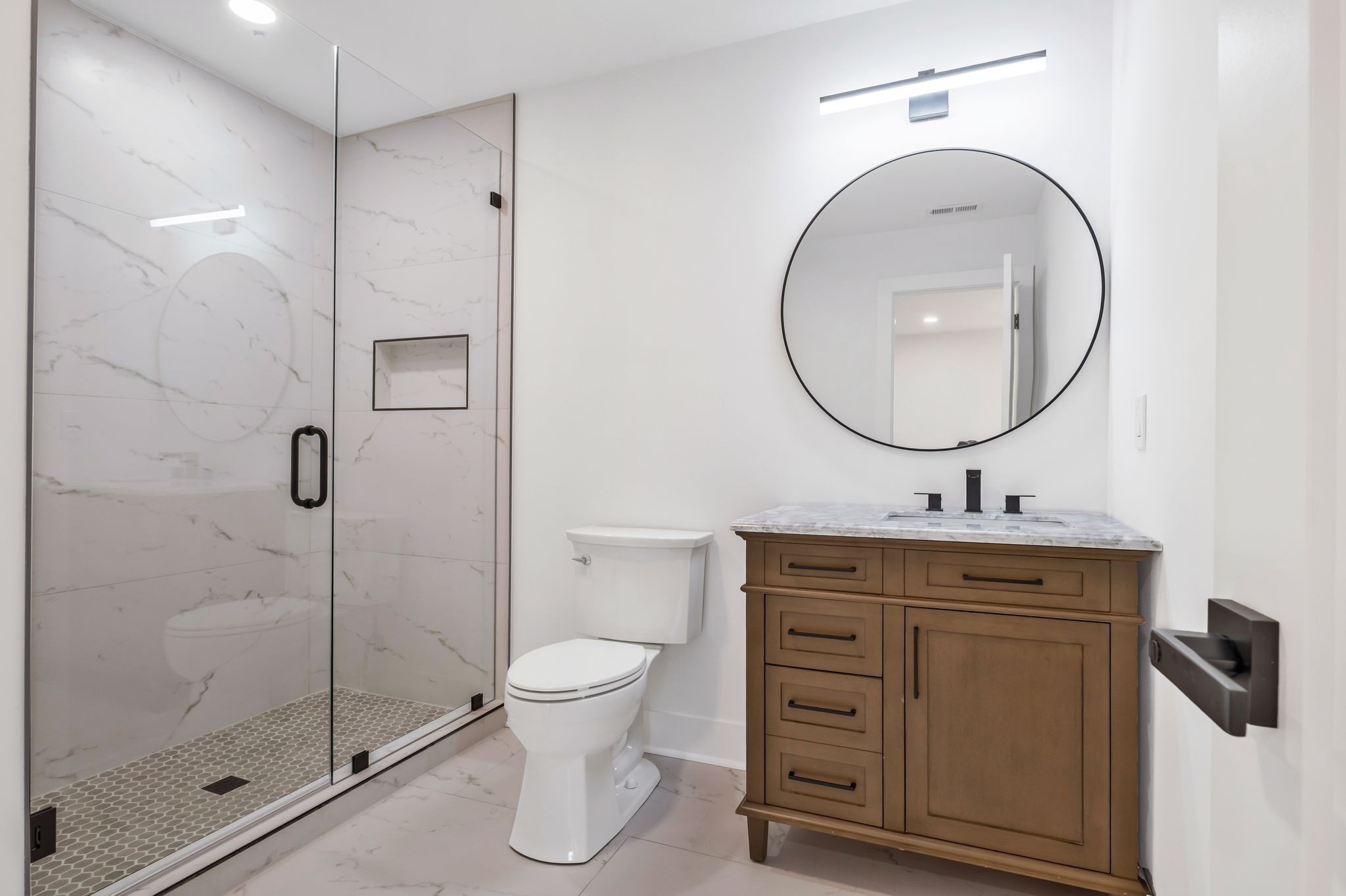 404 Rudolph Avenue Nashville, TN 37206 - Photo 17 of 34 a bathroom with a toilet a sink a mirror and shower