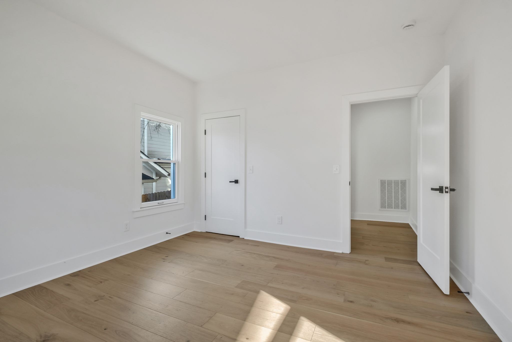 404 Rudolph Avenue Nashville, TN 37206 - Photo 19 of 34 a view of an empty room with wooden floor and a window