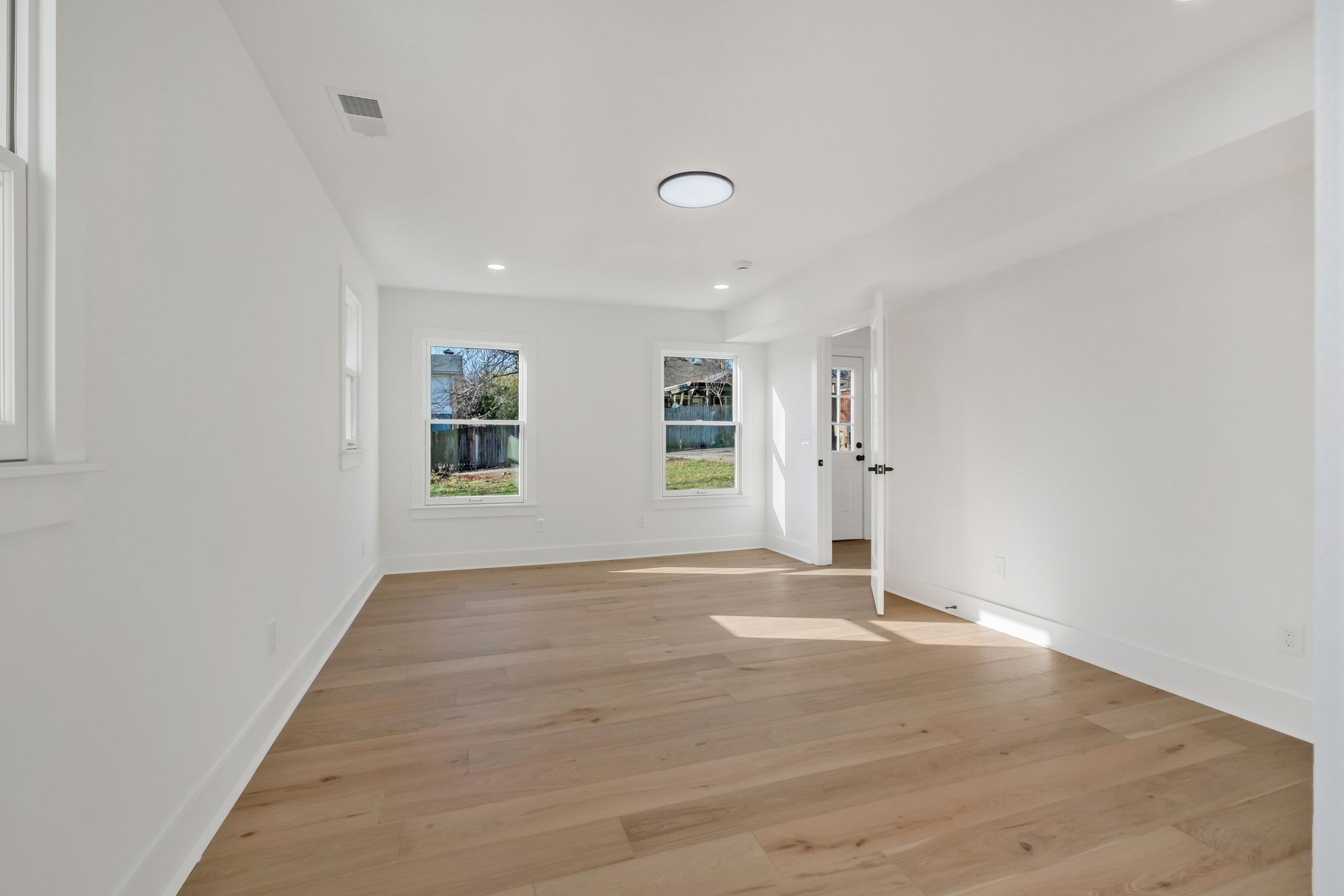 404 Rudolph Avenue Nashville, TN 37206 - Photo 20 of 34 an empty room with wooden floor and windows