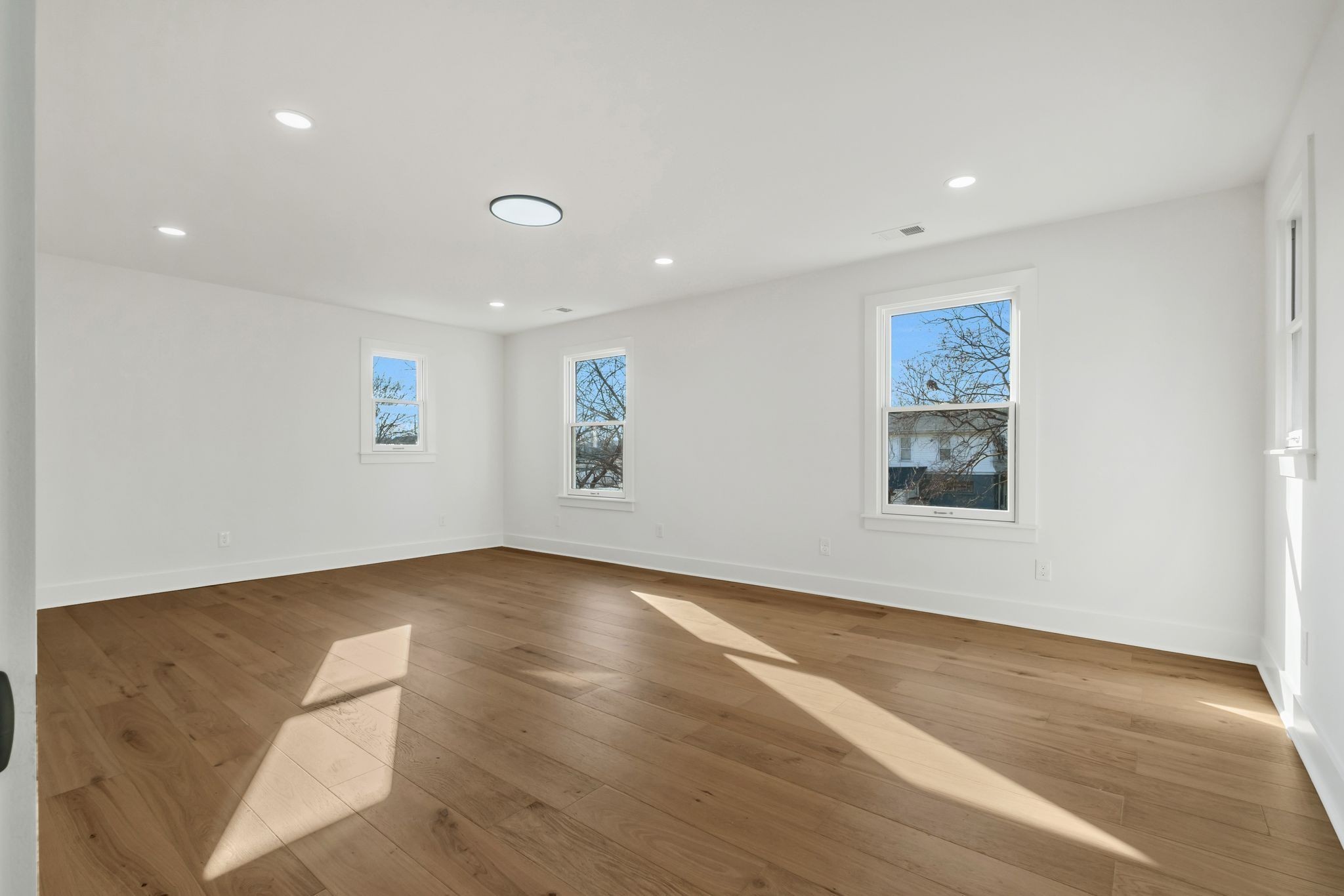 404 Rudolph Avenue Nashville, TN 37206 - Photo 21 of 34 a view of an empty room with wooden floor and a window