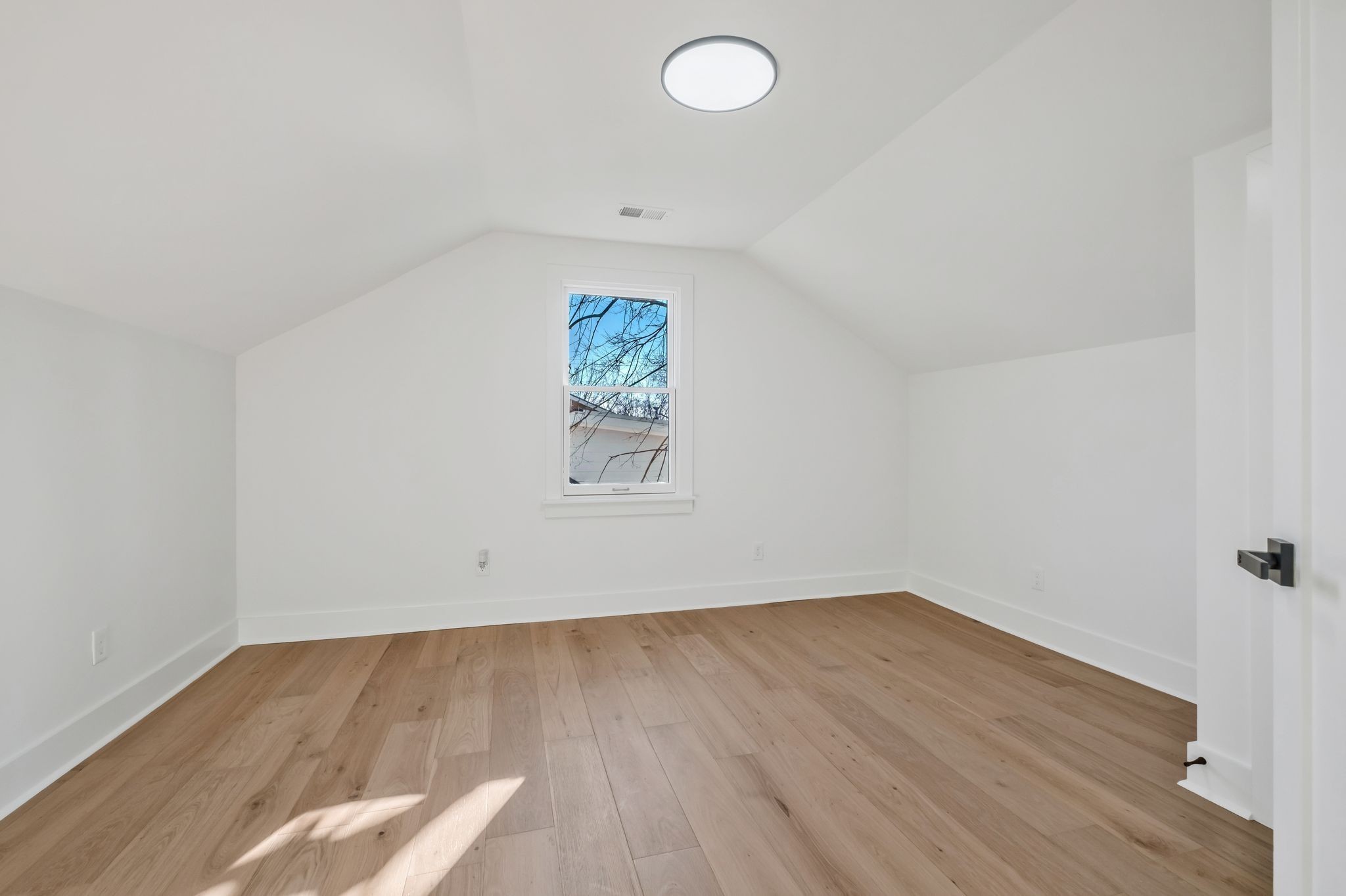 404 Rudolph Avenue Nashville, TN 37206 - Photo 28 of 34 an empty room with wooden floor and windows