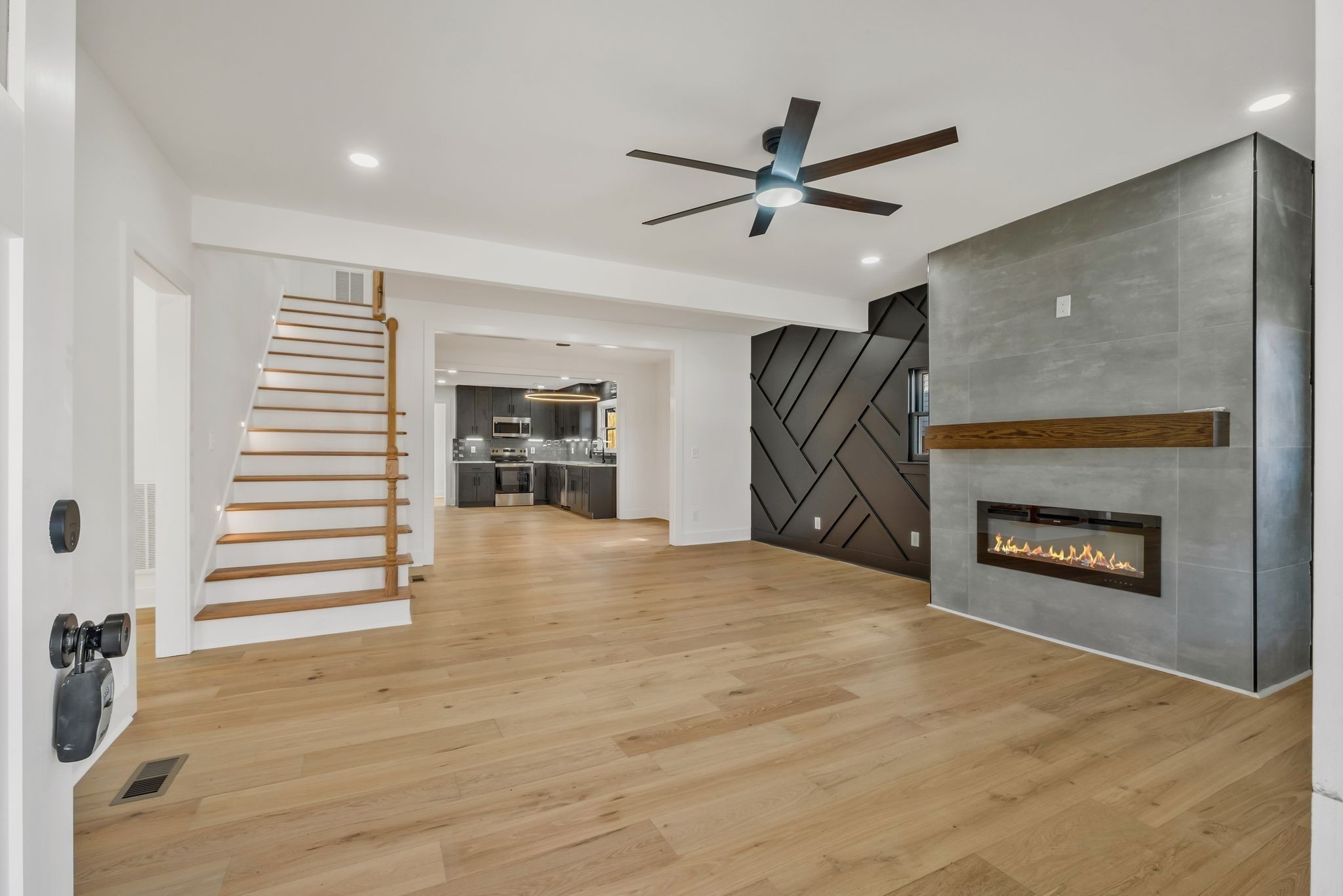 404 Rudolph Avenue Nashville, TN 37206 - Photo 4 of 34 a view of a livingroom with a fireplace a ceiling fan and wooden floor