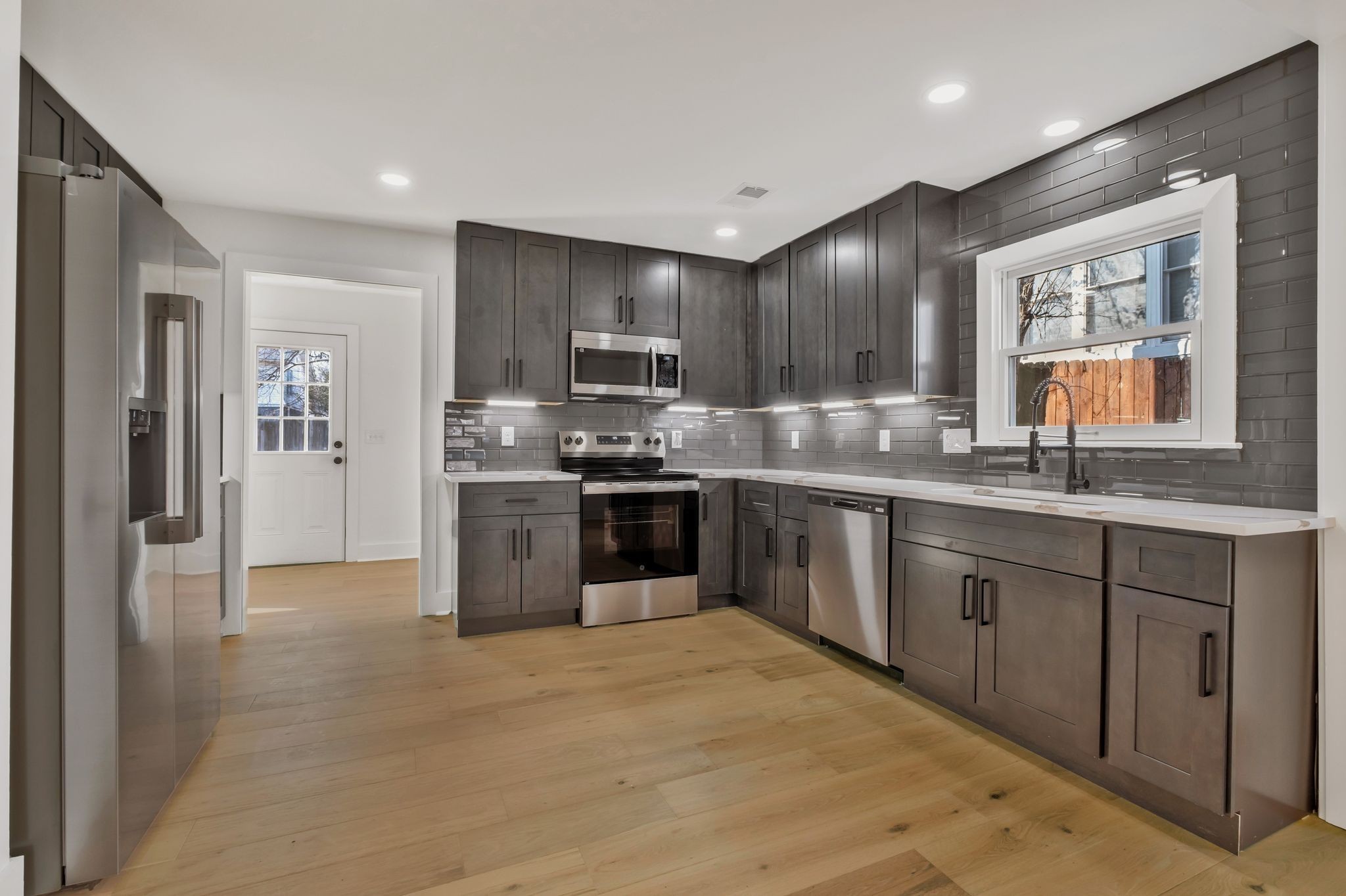 404 Rudolph Avenue Nashville, TN 37206 - Photo 8 of 34 a kitchen with stainless steel appliances granite countertop a refrigerator a sink a stove a microwave a counter space and cabinets
