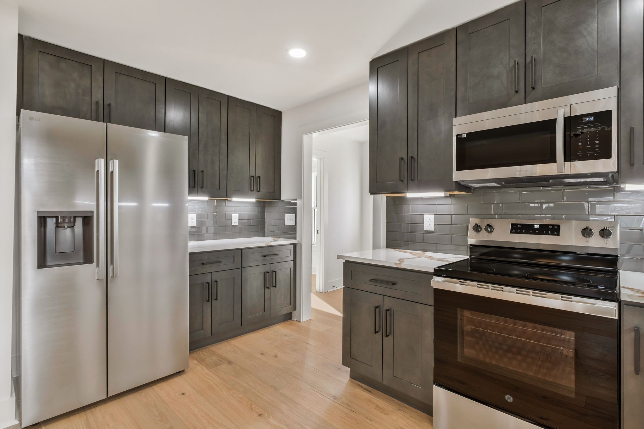 404 Rudolph Avenue Nashville, TN 37206 - Photo 10 of 34 a kitchen with stainless steel appliances wooden cabinets and stove
