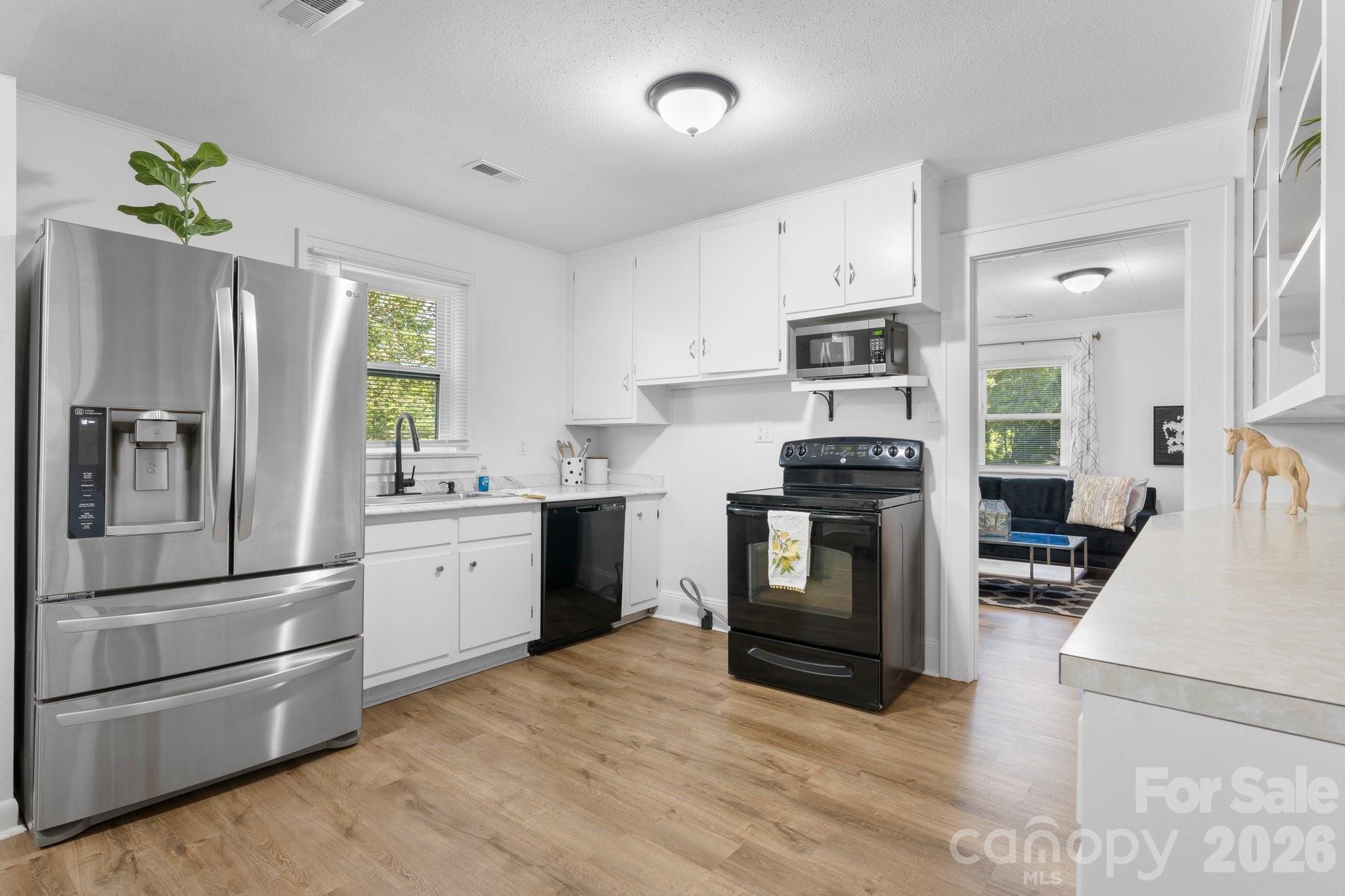 116 Barnes Lane Stony Point, NC 28678 - Photo 12 of 24 a kitchen with granite countertop a refrigerator stove and oven