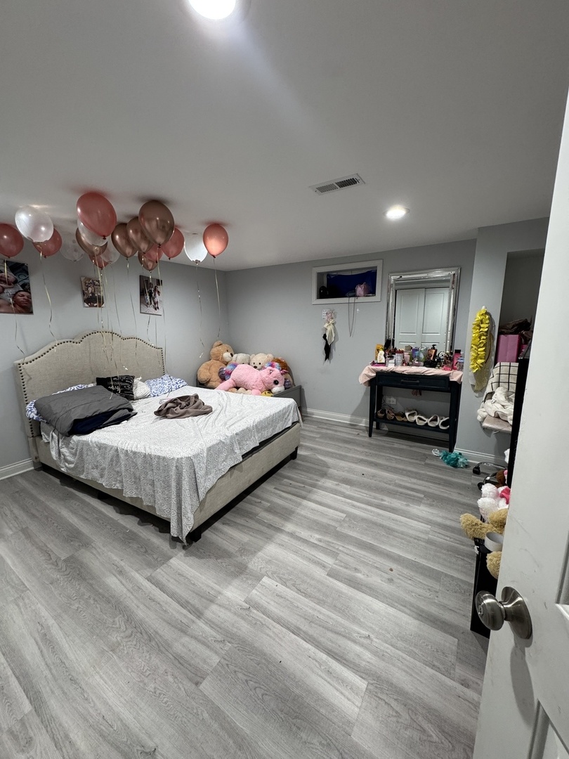 5920 Chicago Avenue Berkeley, IL 60163 - Photo 11 of 13 a bedroom with bed and a chandelier