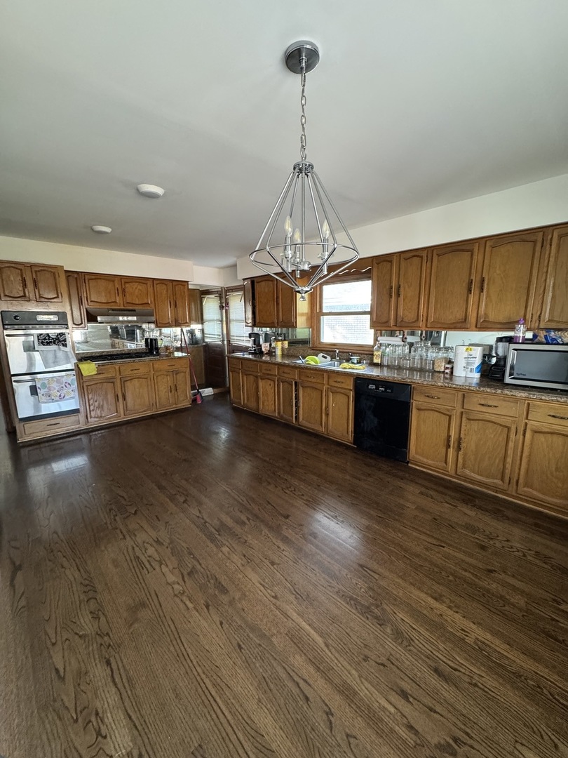 5920 Chicago Avenue Berkeley, IL 60163 - Photo 4 of 13 a kitchen with stainless steel appliances granite countertop a oven a stove and a wooden floors