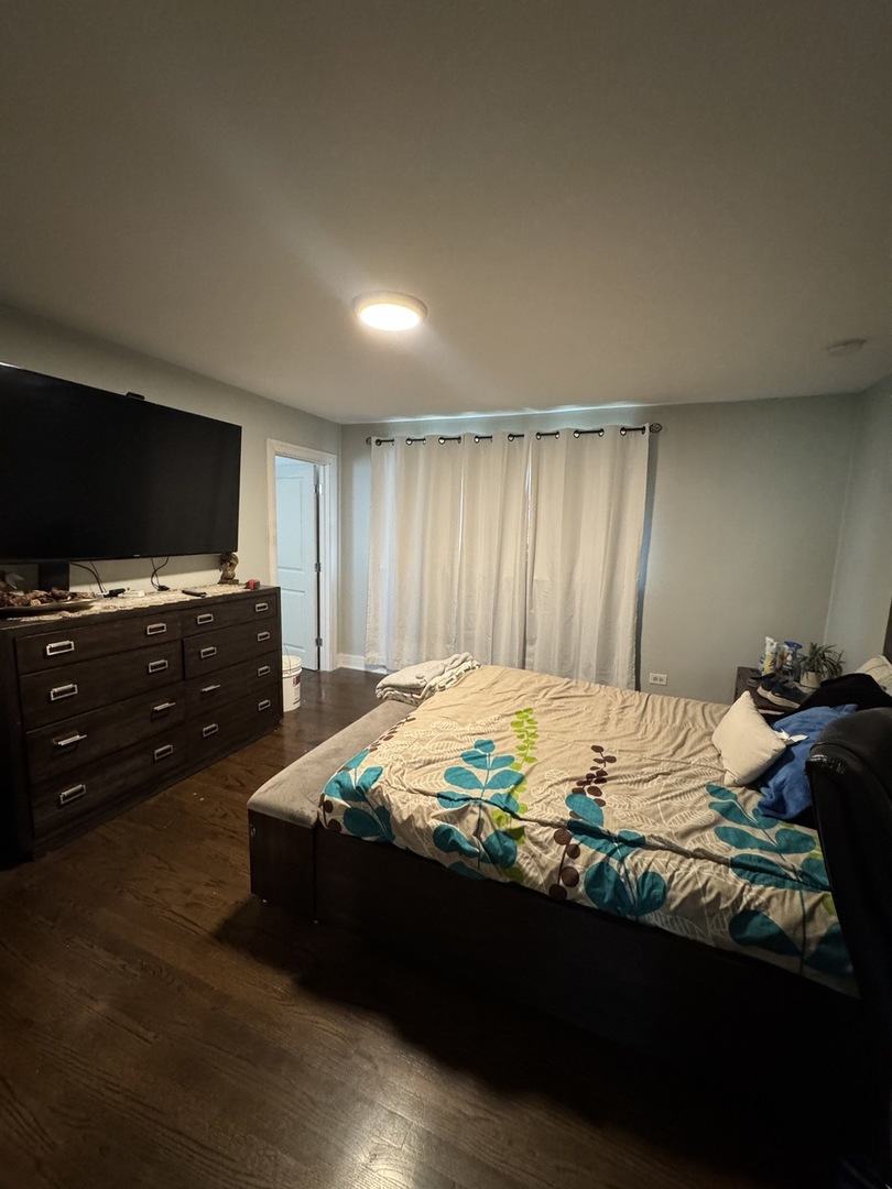 5920 Chicago Avenue Berkeley, IL 60163 - Photo 6 of 13 a bed sitting in a bedroom and flat screen tv