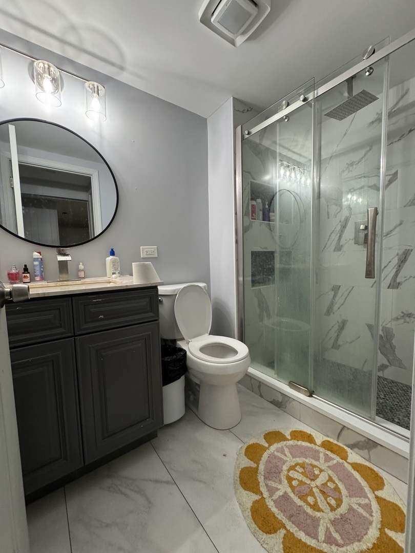5920 Chicago Avenue Berkeley, IL 60163 - Photo 9 of 13 a bathroom with a toilet sink and mirror