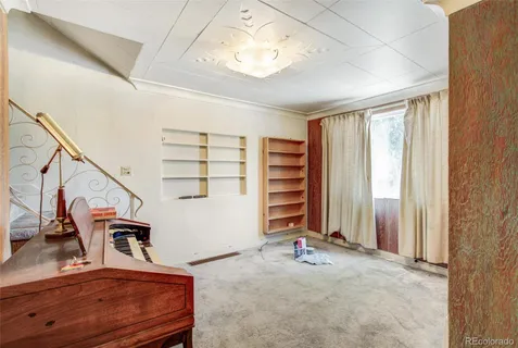 a view of a livingroom with furniture and staircase