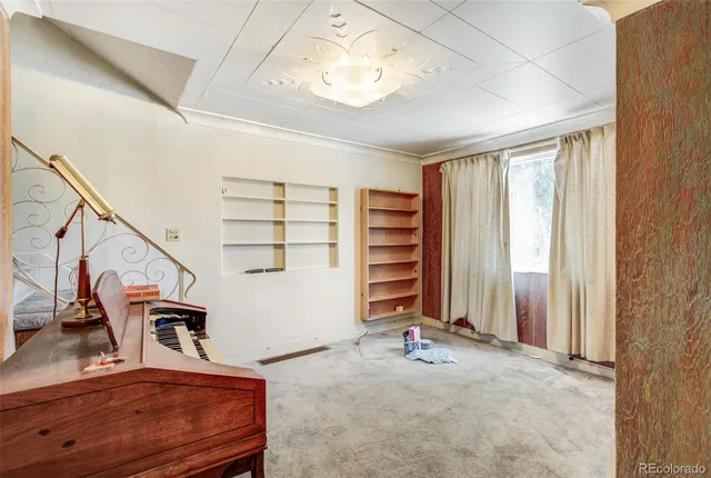 a view of a livingroom with furniture and staircase