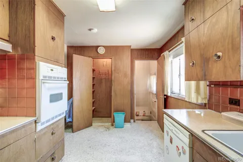 a spacious bathroom with a granite countertop sink a mirror and a bathtub