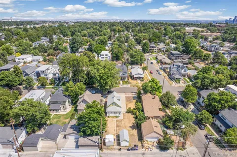 an aerial view of residential houses with outdoor space and street view
