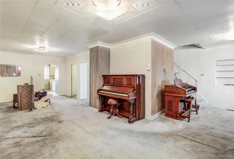 a living room with furniture and a piano