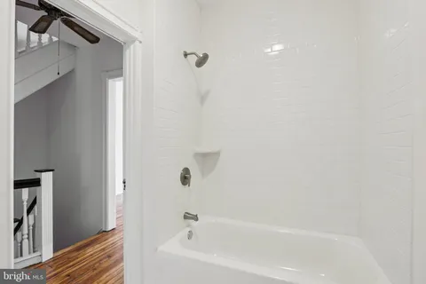 a view of hallway with wooden floor