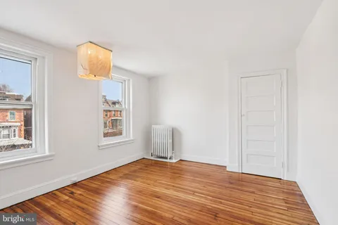 a view of a room with wooden floor