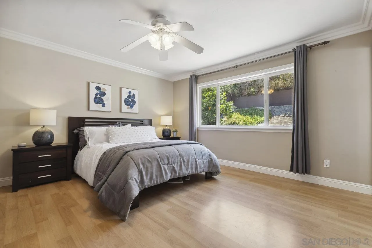304 Avenida De Los Claveles Encinitas, CA 92024 - Photo 14 of 27 a bedroom with a large bed and a window