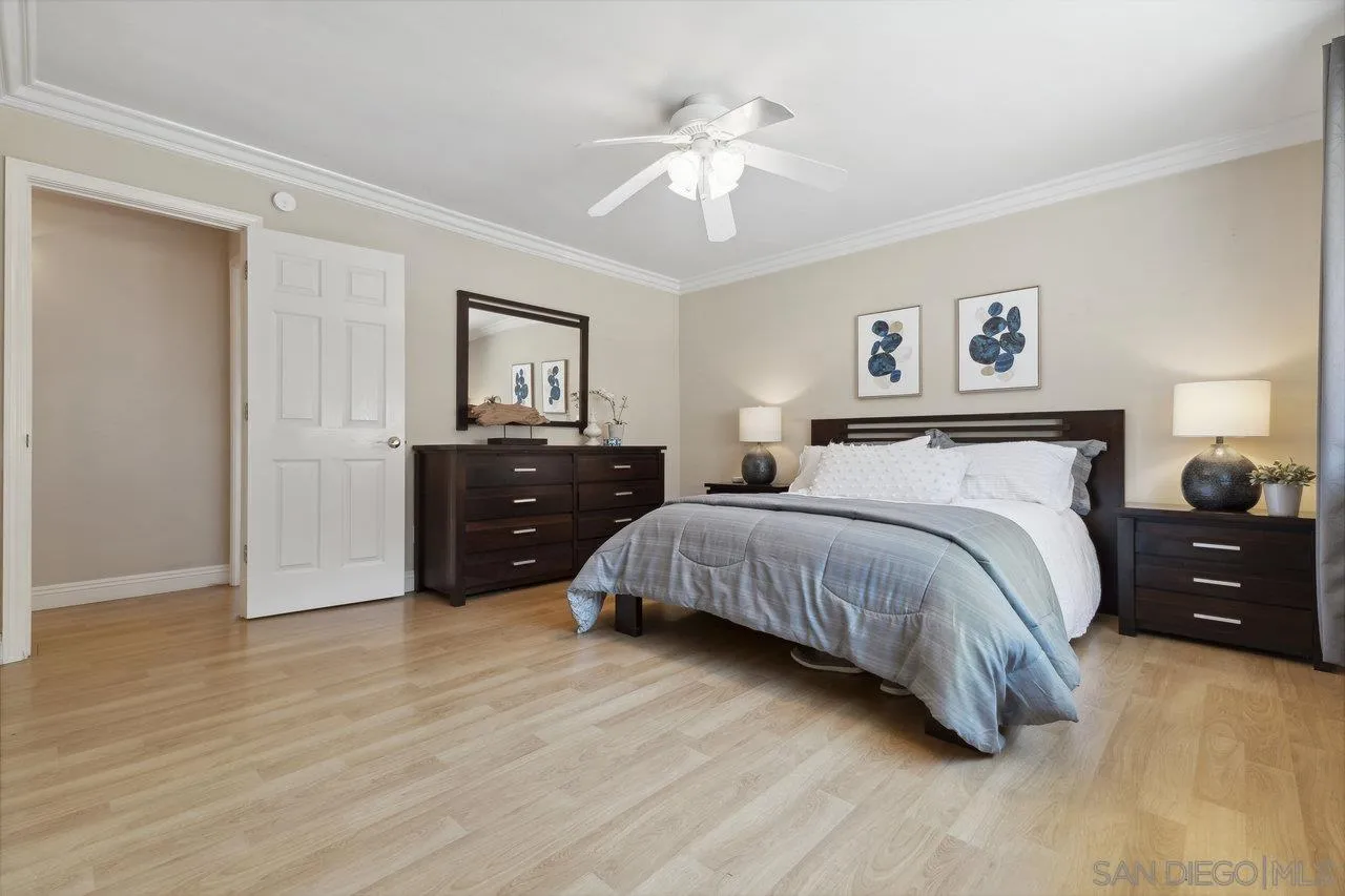 304 Avenida De Los Claveles Encinitas, CA 92024 - Photo 15 of 27 a spacious bedroom with a bed and a chandelier