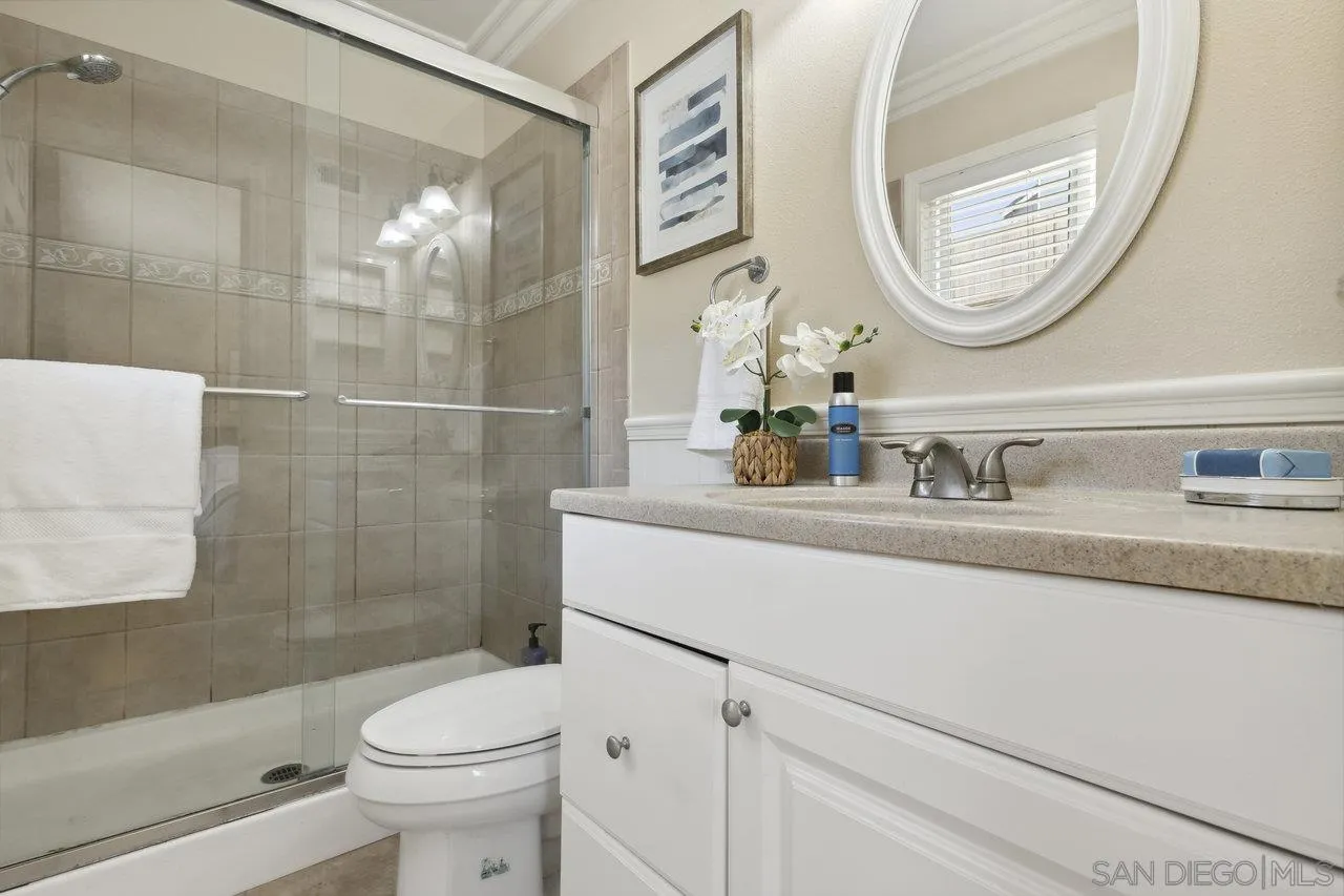 304 Avenida De Los Claveles Encinitas, CA 92024 - Photo 17 of 27 a bathroom with a sink a toilet and a mirror