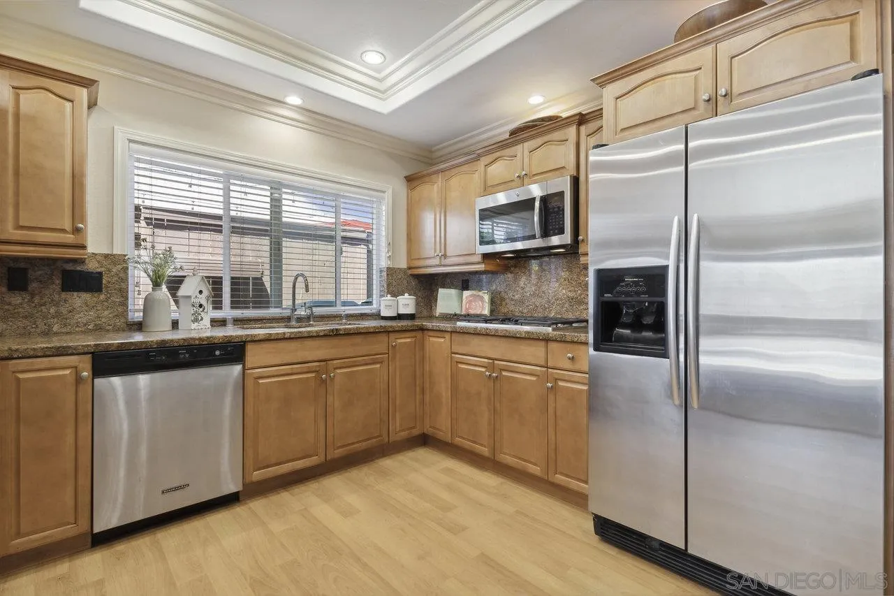 304 Avenida De Los Claveles Encinitas, CA 92024 - Photo 7 of 27 a kitchen with stainless steel appliances granite countertop a refrigerator a sink and white cabinets
