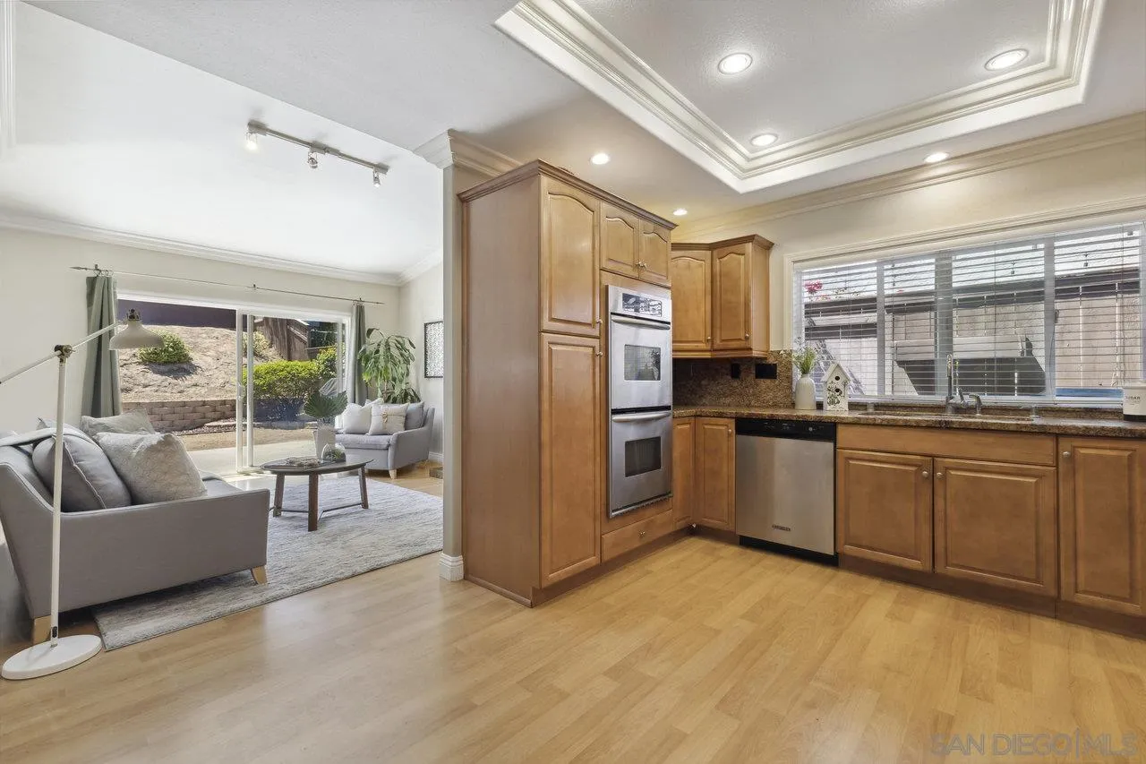 304 Avenida De Los Claveles Encinitas, CA 92024 - Photo 9 of 27 a kitchen with granite countertop a refrigerator and white cabinets
