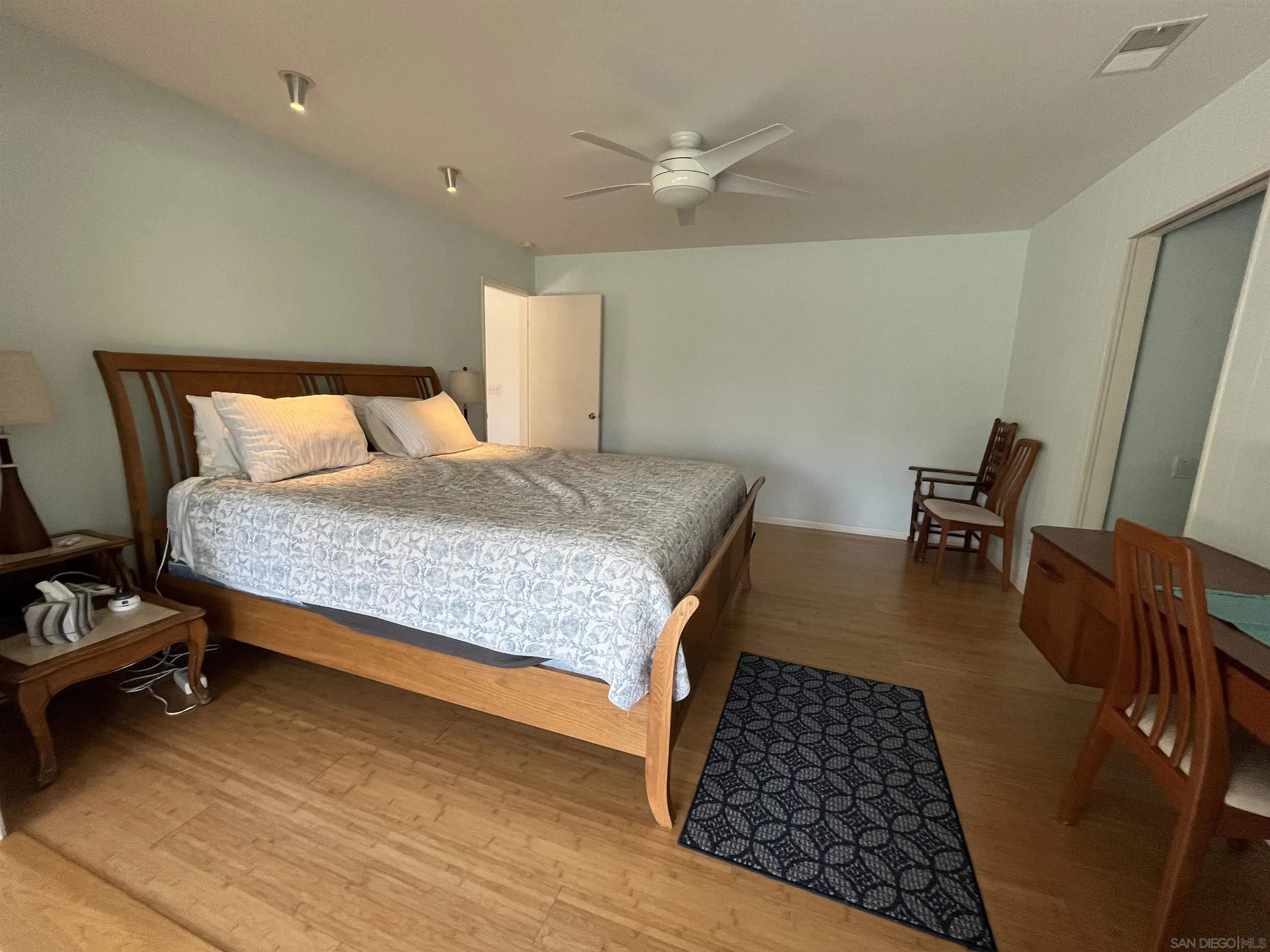 4688 Sun Valley Road Del Mar, CA 92014 - Photo 17 of 40 a bedroom with a bed and wooden floor