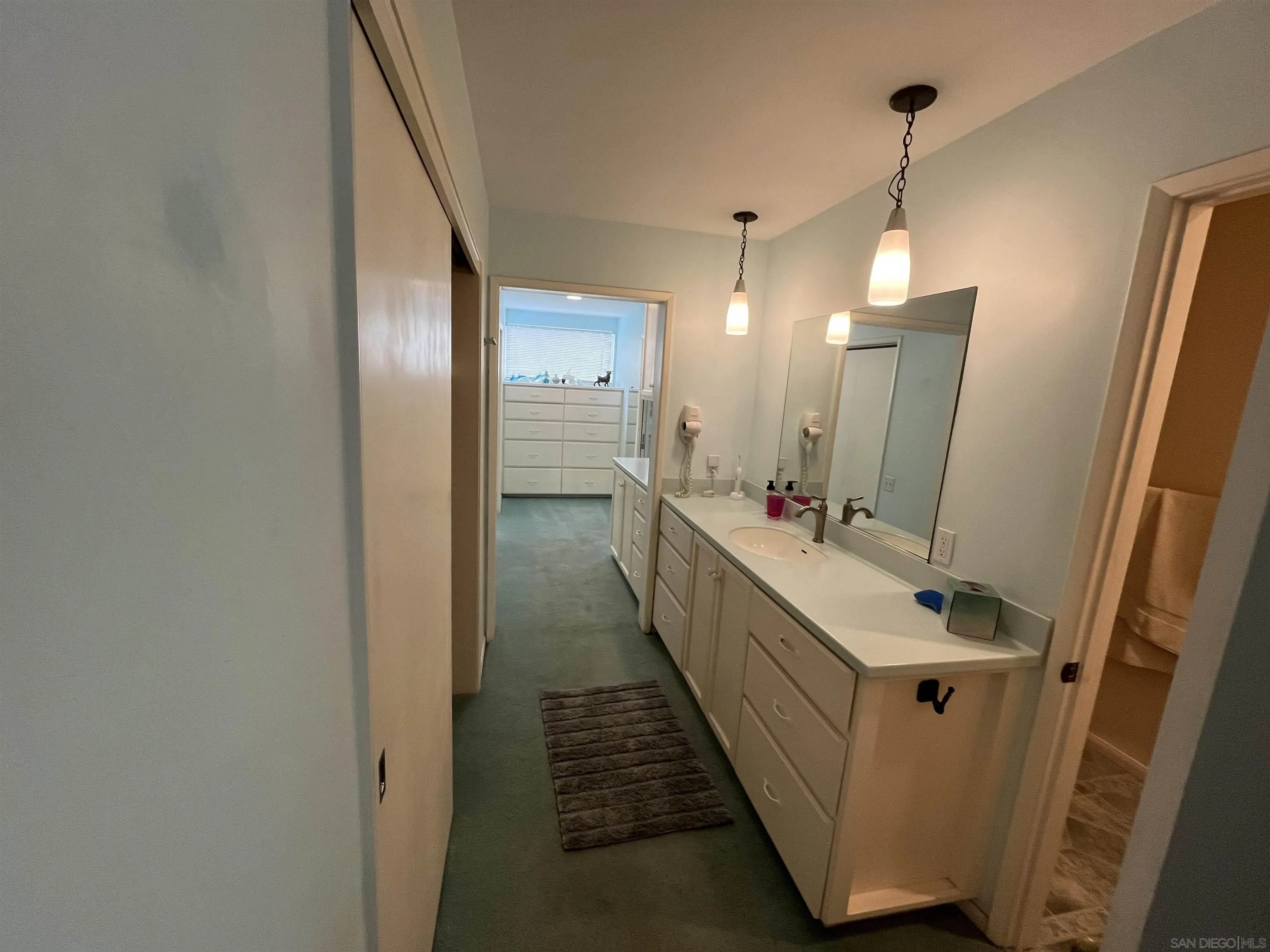 4688 Sun Valley Road Del Mar, CA 92014 - Photo 24 of 40 a bathroom with a double vanity sink and mirror