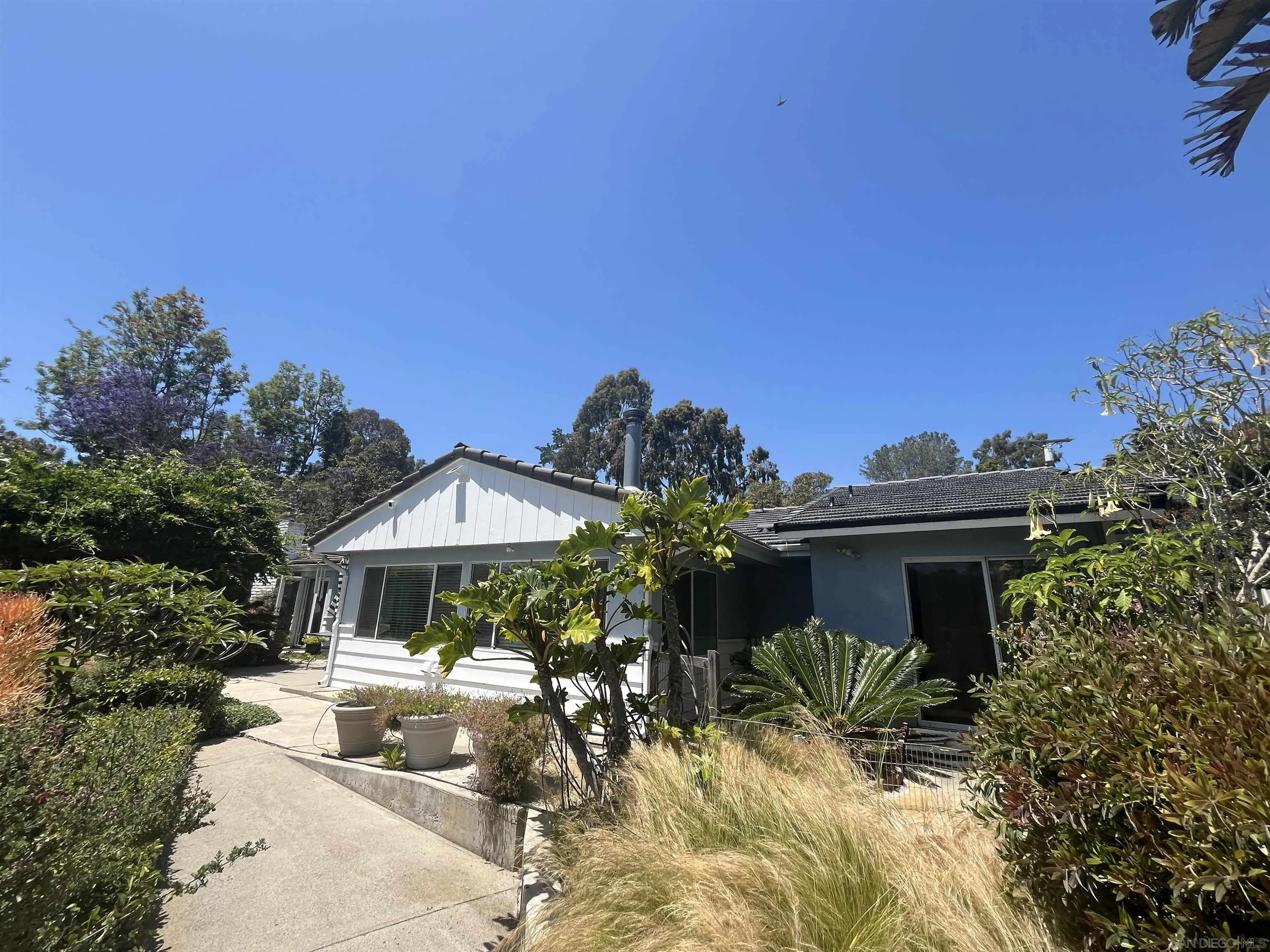 4688 Sun Valley Road Del Mar, CA 92014 - Photo 3 of 40 a front view of house with yard outdoor seating and entertaining space