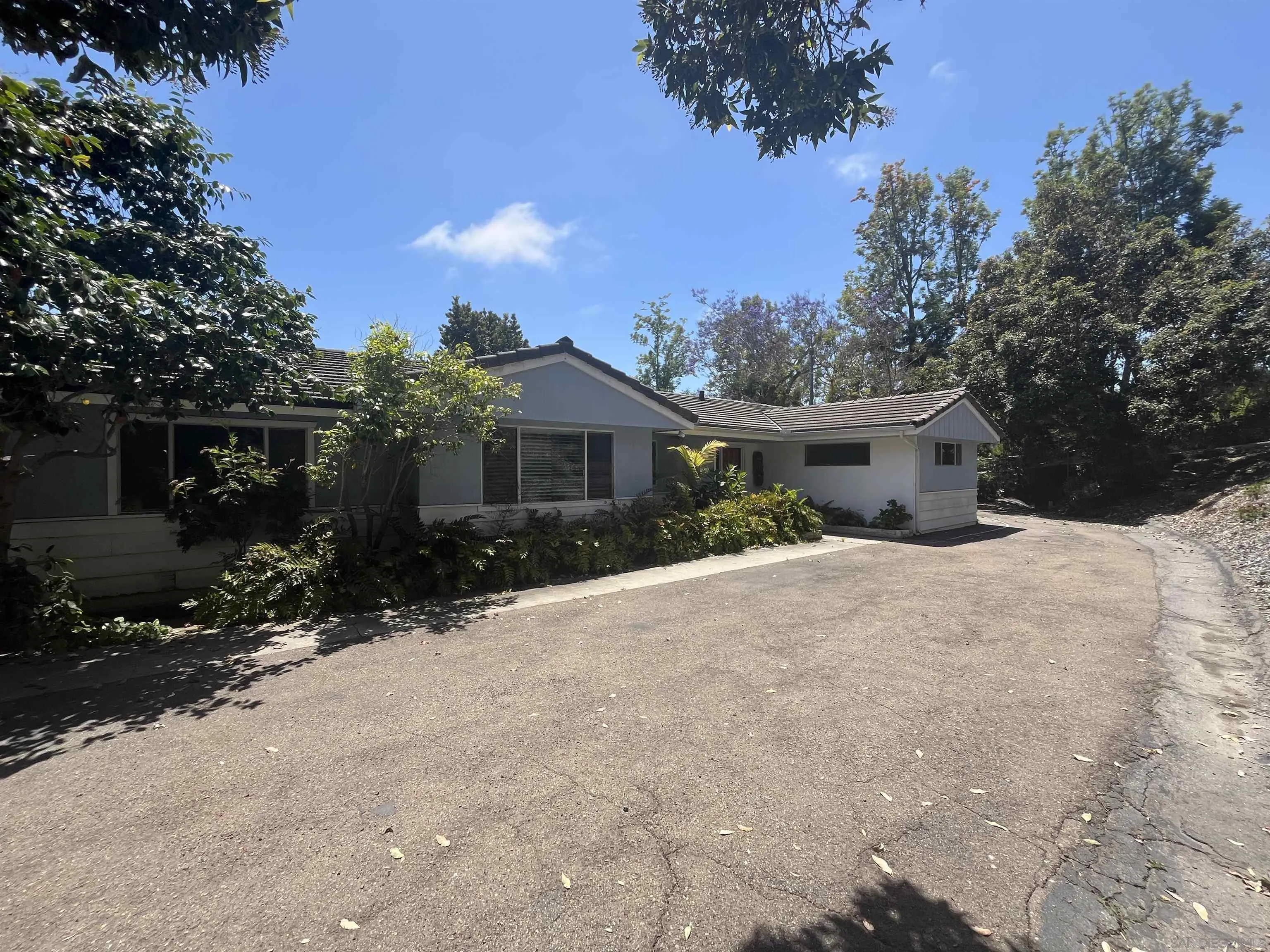 4688 Sun Valley Road Del Mar, CA 92014 - Photo 35 of 40 a view of a house with a yard and potted plants