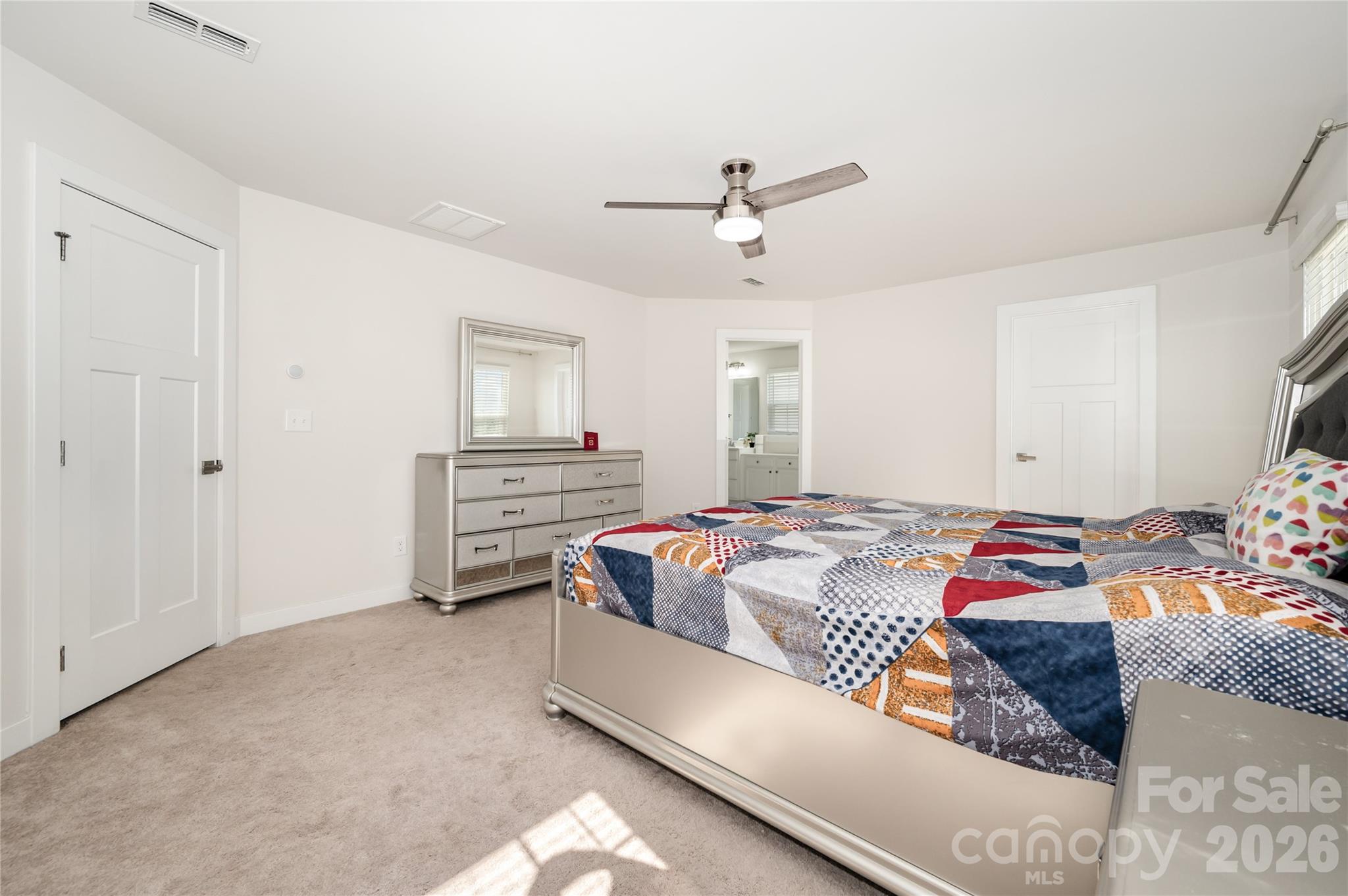 7222 Waterwheel Street Southwest Concord, NC 28025 - Photo 20 of 48 a bedroom with a bed and ceiling fan