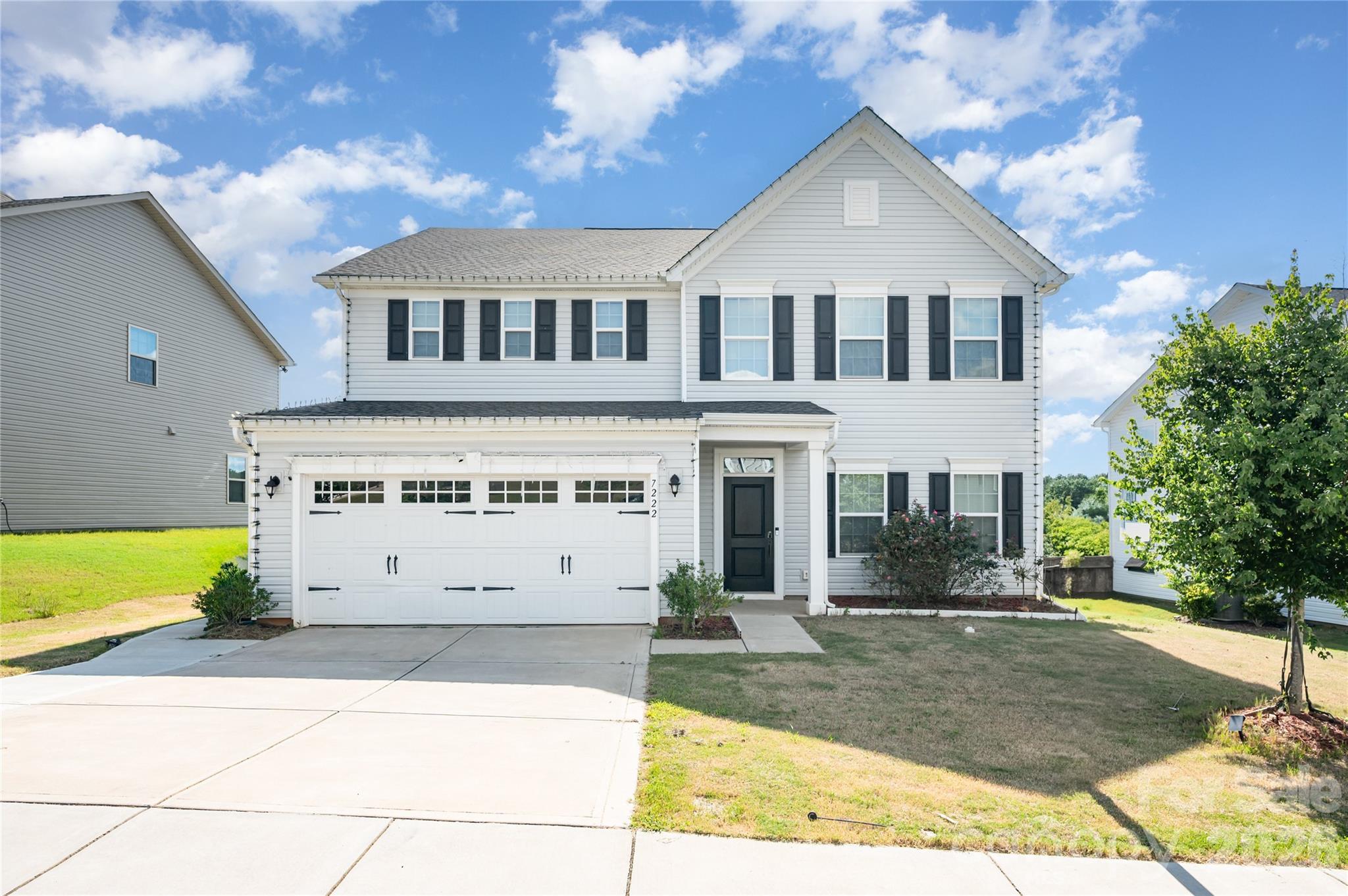 7222 Waterwheel Street Southwest Concord, NC 28025 - Photo 3 of 48 a front view of a house with a yard