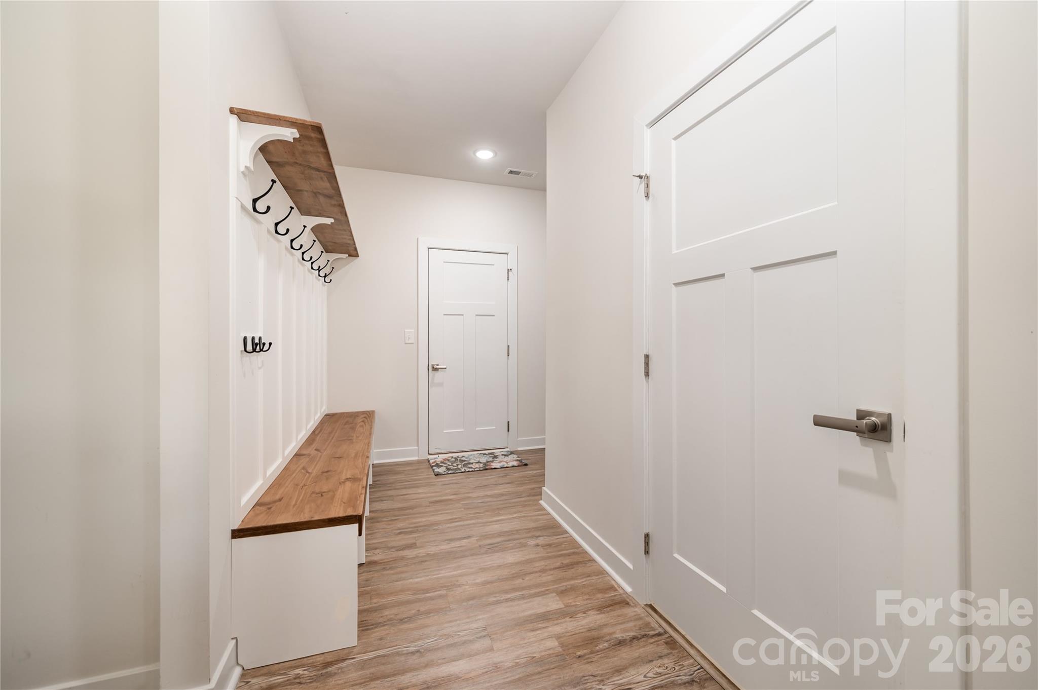 7222 Waterwheel Street Southwest Concord, NC 28025 - Photo 32 of 48 a view of a hallway with wooden floor and staircase