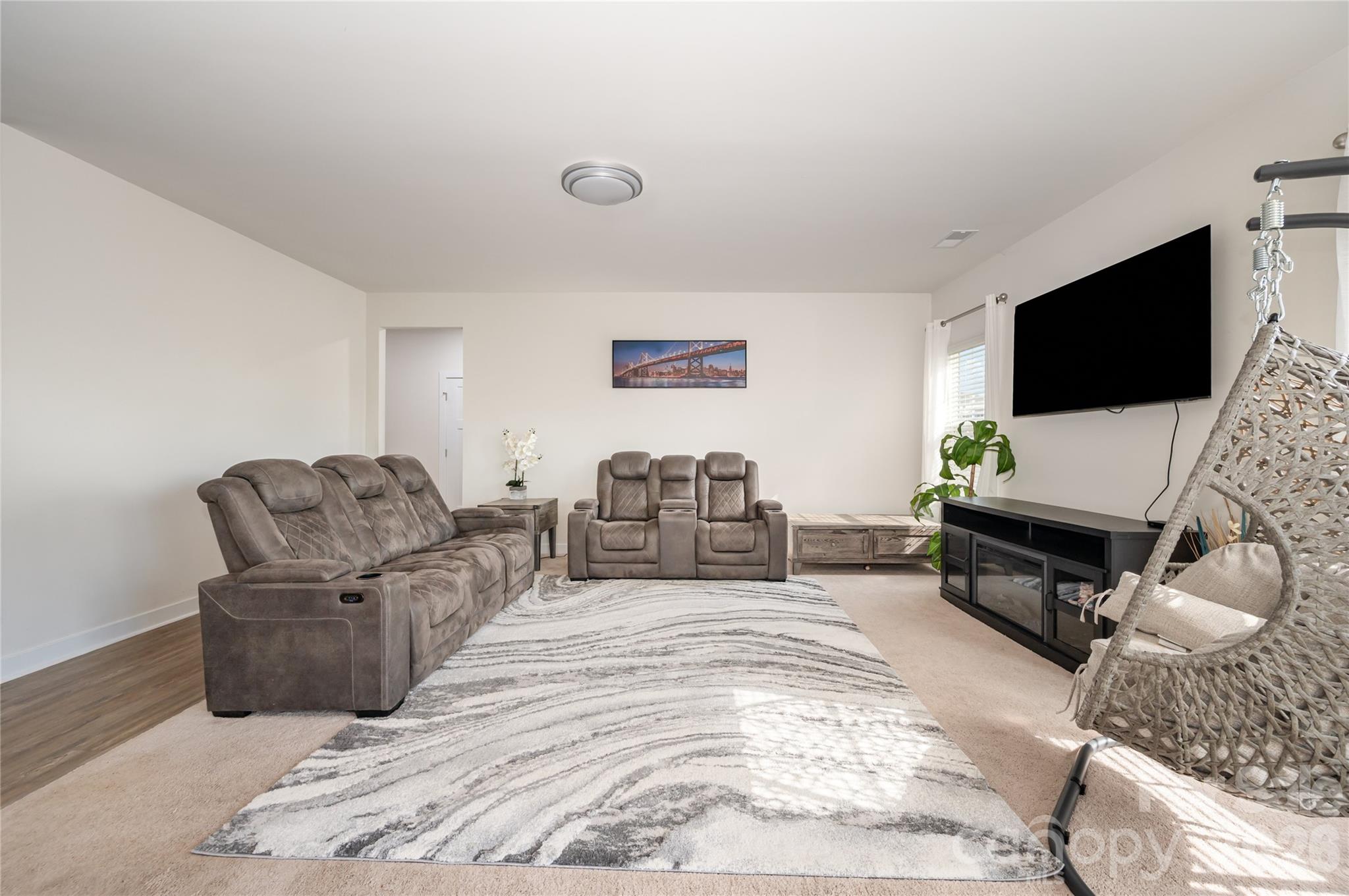 7222 Waterwheel Street Southwest Concord, NC 28025 - Photo 10 of 48 a living room with furniture and a flat screen tv