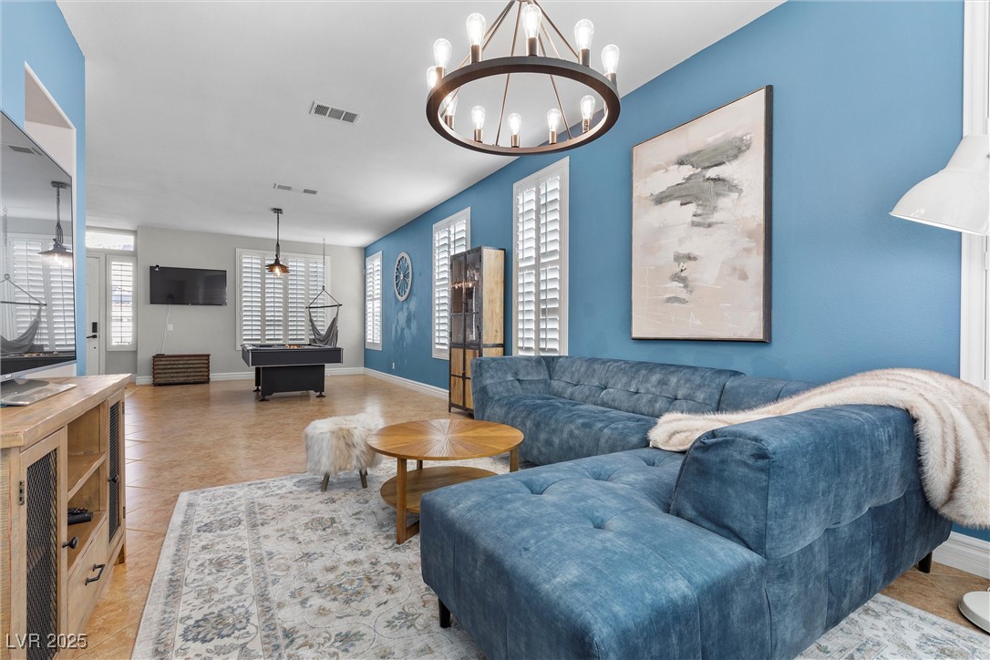 9475 Castillana Court Las Vegas, NV 89147 - Photo 1 of 34 Living room featuring an inviting chandelier, base
