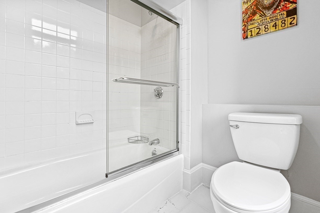 5 Babson Street, Unit 2 Gloucester, MA 01930 - Photo 15 of 23 a white toilet sitting next to a bath tub and a shower