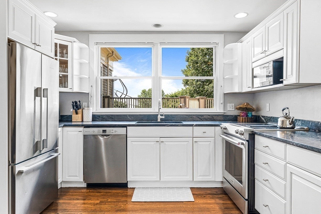 5 Babson Street, Unit 2 Gloucester, MA 01930 - Photo 6 of 23 a kitchen with stainless steel appliances granite countertop a stove a sink and a refrigerator
